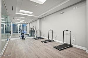 a gym with a row of exercise bikes in a room at Oceanview Studio w/kitchen, pool, tiki bar in Daytona Beach