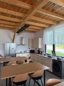 a kitchen with a wooden table and chairs and a table and a counter at Zen Resort and Winery in Slănic