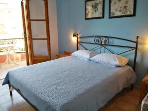a bedroom with a bed with two pillows on it at Villa Mary Galini in Ireon