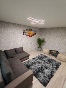 a living room with a couch and a rug at Agnes Apartament in Valmiera