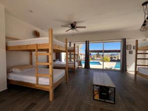 a bedroom with bunk beds with a view of a pool at The Colony La Ventana in La Ventana +37 photos