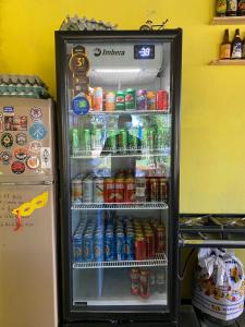 a refrigerator filled with drinks and soda at COMPARTILHADO Do TERRÃO in Três Marias