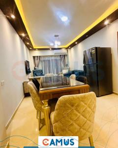 a living room with a table and a refrigerator at CAMUS 343, Princess Resort in Hurghada