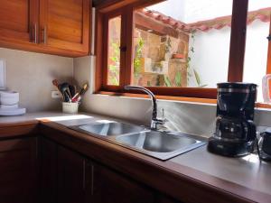a kitchen counter with a sink and a window at Casa ONCE ONCE in Villa de Leyva +53 photos