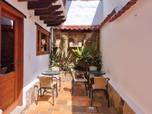 a patio with tables and chairs in a building at Casa ONCE ONCE in Villa de Leyva