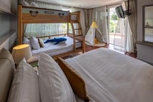 a bedroom with two beds and a bunk bed at The Delfini Hua Hin in Hua Hin