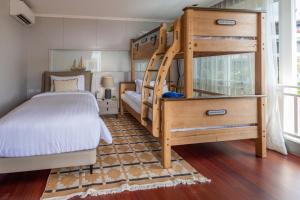a bedroom with a bunk bed and a ladder at The Delfini Hua Hin in Hua Hin