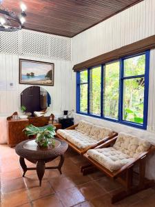 a living room with two couches and a table at Hotel Don Ernesto By La Chimba in San José