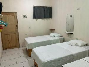 a hospital room with two beds and a window at Miami Studios DR in Santo Domingo