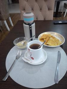 a cup of coffee and a plate of food on a table at The Scion Garden in Naivasha