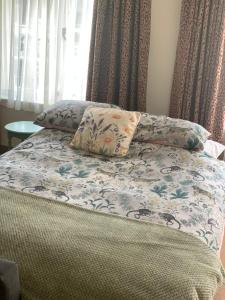 a bed with two pillows on top of it at The Old Stores in Bury Saint Edmunds
