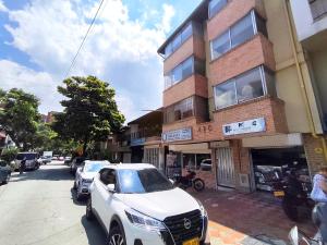 a white car parked in front of a building at ABC-53 Housing in Medellín
