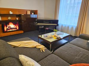 a living room with a couch and a piano at Old Town Cathedral Views - Steps from Dome Square -Friends & Family stay in Riga