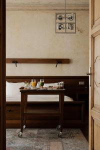 a room with a bed and a table with food on it at Hotel Stary in Krakow