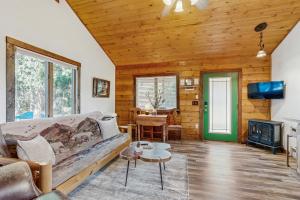 a living room with a couch and a tv at Bear Chalet in Bigfork
