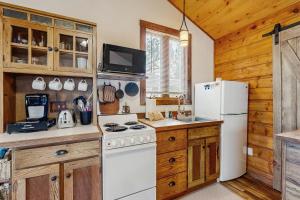 a kitchen with a white refrigerator and a stove at Bear Chalet in Bigfork
