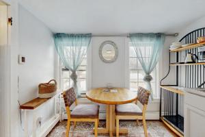 a dining room with a wooden table and chairs at The Hilltop - West Wing in Waterbury