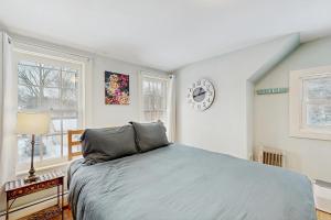 a bedroom with a bed and a clock on the wall at The Hilltop - West Wing in Waterbury
