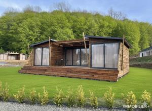 a cabin in the middle of a field of grass at Domaine LAPEDAGNE in Arette