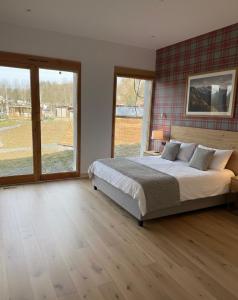 a bedroom with a large bed and a large window at Domaine LAPEDAGNE in Arette