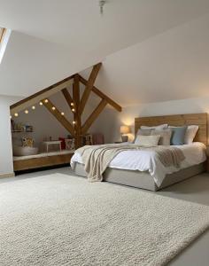 a bedroom with a large white bed and a white rug at Domaine LAPEDAGNE in Arette