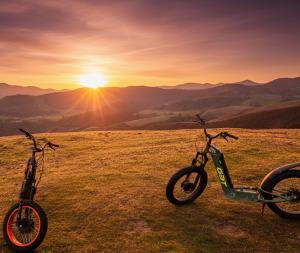 two bikes parked in a field with the sunset in the background at Domaine LAPEDAGNE in Arette