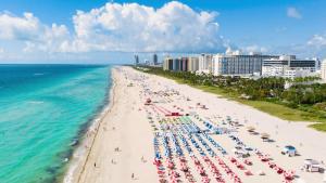 an aerial view of a beach with umbrellas and people at Casa Collins in Miami Beach