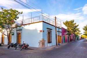 a group of motorcycles parked on the side of a street at Suites Patio Antequera in Oaxaca City