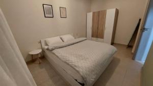 a small bedroom with a bed and a cabinet at Christina Apartment 2 in Drama