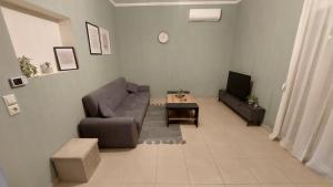 a living room with a couch and a tv at Christina Apartment 2 in Drama