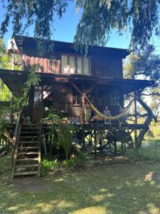 a tree house with people standing in front of it at Cabaña La Colmena in Tigre +18 photos