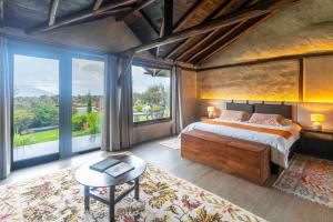 a bedroom with a large bed and a large window at Chilcabamba Lodge in Machachi