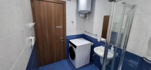 a bathroom with a toilet and a glass door at Seafront Apartment - Balcony over the Harbour in Marsaskala +20 photos