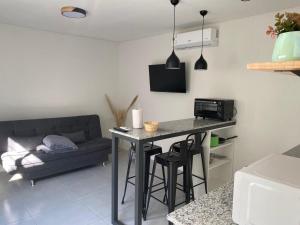 a living room with a table and a couch at Apartamentos céntricos in Paysandú