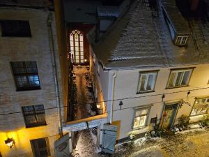 an old building with a window in a city at night at Old Town Cathedral Views - Steps from Dome Square -Friends & Family stay in Riga