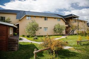 a large house with a yard in front of it at Patagonia Hostel in El Chalten