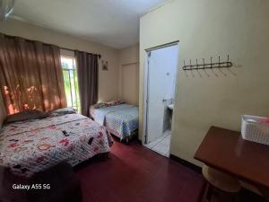 a bedroom with a bed and a door to a bathroom at Hotel Villas de San Juan, Guatemala in Guatemala