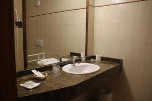 a bathroom counter with a sink and a mirror at Hotel Soldeu Maistre in Soldeu +28 photos