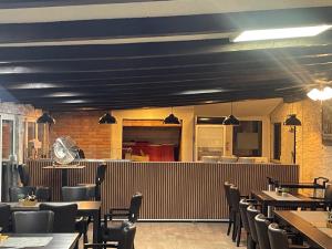 a restaurant with blue ceilings and tables and chairs at Bonavita Zaton in Zaton +26 photos