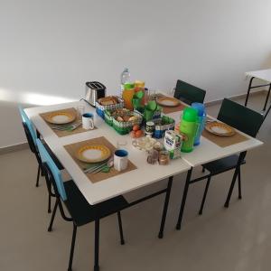 a table with plates of food and drinks on it at Artimar- B&Breakfast in Ponta do Sol