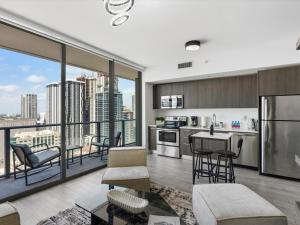 an open kitchen and living room with a view of a city at 29th Floor Balcony Studio Miami Skyline Views in Miami
