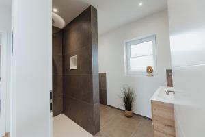 a bathroom with a shower and a sink at Ferienhaus HeimatLay in Mörsdorf +39 photos