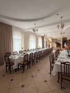 a large dining room with long tables and chairs at Zajazd Jerzmanowa in Jakubów