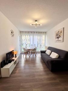 a living room with a couch and a table at Cosy 4 pers in Chalon-sur-Saône
