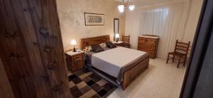 a bedroom with a bed and a desk and a chair at Seafront Apartment - Balcony over the Harbour in Marsaskala