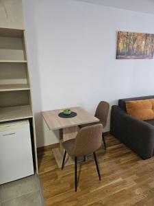a living room with a table and a couch at Garden Doboj in Doboj