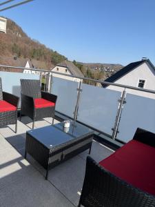 a group of chairs and a table on a patio at AdiFerienwohnung in Gerolstein