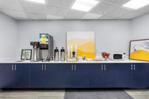 a counter with blue cabinets in a room at Super 8 by Wyndham Chicago IL in Chicago