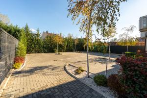 a courtyard with a tennis court and a tree at Esther Line Apartments-Near Iulius Mall, Self Check-in,Free Private Parking subject to availability in Timişoara