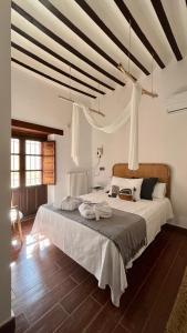 a bedroom with a large bed in a room at Hotel La Casa del Canónigo in Caracenilla